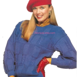 May include: A woman wearing a red beret, blue sweater, red gloves, and red skirt. The blue sweater has a cable knit design. The gloves have silver studs. The text "neonjuly.etsy.com" is visible.