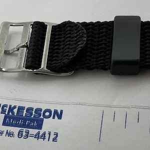 May include: A black woven watch strap with a silver buckle that says "Stainless Steel".