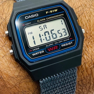 Casio F-91-W-1 watch with Custom Nylon very lightweight Band Water Resistant Alarm Chronograph Digital Watch in Original Box and papers.