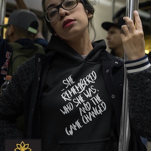 She Remembered Who She Was and the Game Changed - Unisex Hoodie or crew neck sweatshirt