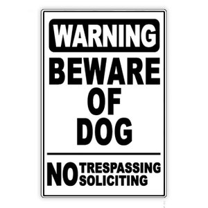 May include: Black and white warning sign with the text "WARNING BEWARE OF DOG NO TRESPASSING SOLICITING".