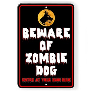 May include: A black and red metal sign with the text "Beware of Zombie Dog Enter at Your Own Risk". A yellow circle with a black silhouette of a dog's head is in the upper left corner.