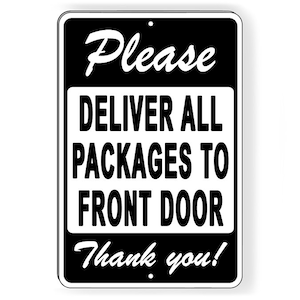 May include: Black and white rectangular metal sign with the words "Please DELIVER ALL PACKAGES TO FRONT DOOR Thank you!" in a mix of script and block letters. The sign has a black border and a small hole at the top for hanging.