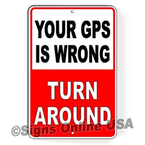 May include: Red and white metal sign with the text "Your GPS is wrong Turn Around" in black lettering. The sign has a white border and a hole at the top for hanging.