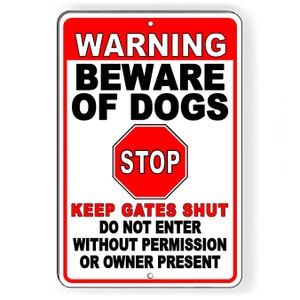May include: A white and red warning sign with black text that reads "WARNING BEWARE OF DOGS STOP KEEP GATES SHUT DO NOT ENTER WITHOUT PERMISSION OR OWNER PRESENT".
