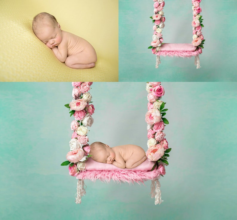 May include: A newborn baby sleeping on a pink swing decorated with pink and white flowers. The swing is hanging from a light blue background.