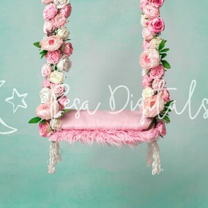 May include: A pink swing with a fluffy cushion, decorated with pink and white flowers. The swing is hanging from a light blue background.