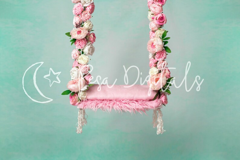 May include: A pink swing with a fluffy cushion, decorated with pink and white flowers. The swing is hanging from a light blue background.