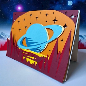 Skiktat rymdkort SVG, 3D Saturnus Planet Pappersklippkort Cricut Silhouette, Astronomi Presentkort, Celestial Shadow Box, Digital Nedladdning