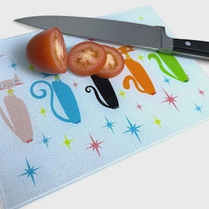 May include: A set of three ceramic mugs with a speckled, matte finish. The mugs are in shades of cream, light gray, and dark gray. Each mug has a simple, minimalist design and a rounded handle. Perfect for coffee or tea.