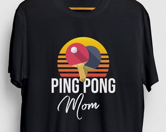 Könnte beinhalten: Schwarzes T-Shirt mit einer Retro-Grafik von zwei Tischtennis Schlägern und dem Text "PING PONG Mama".