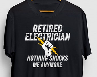 May include: Black t-shirt with white text that reads "Retired Electrician" and "Nothing shocks me anymore". A yellow lightning bolt and fist are in the design.