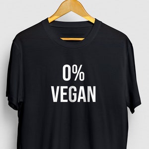 May include: Black t-shirt with white text that reads "0% VEGAN".