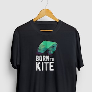 May include: Black t-shirt with a green and blue kite graphic and the text "BORN TO KITE" in white.