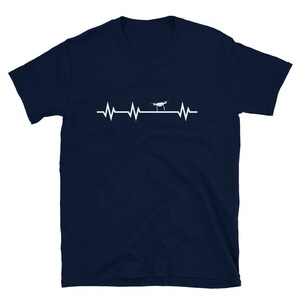 May include: A navy blue t-shirt with a white graphic of a drone flying over a heartbeat line.