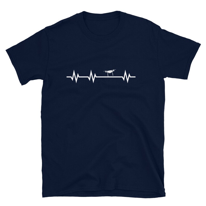 May include: A navy blue t-shirt with a white graphic of a drone flying over a heartbeat line.