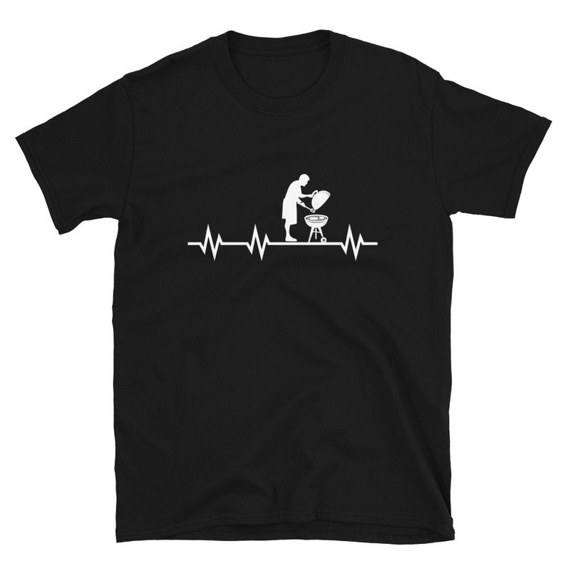 May include: Black t-shirt with a white silhouette of a person grilling and a heartbeat graphic with the text "Grillin'"
