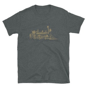 May include: A dark heather grey t-shirt with a vintage illustration of a steam locomotive in gold. The locomotive is facing right and has a large smokestack.