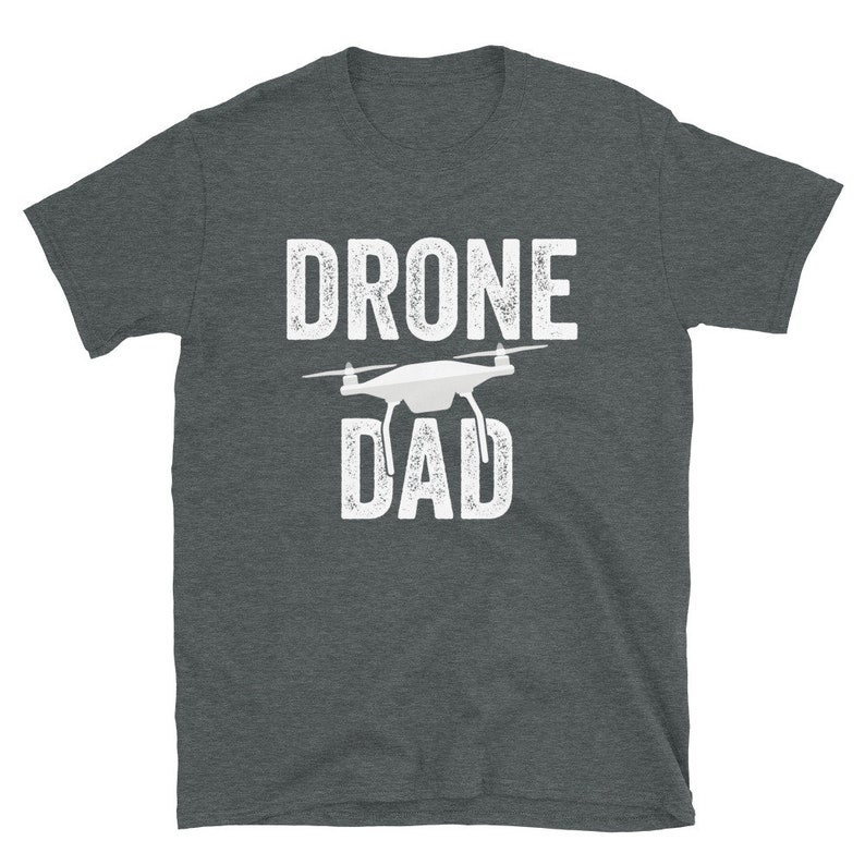 May include: A dark heather grey t-shirt with a white graphic of a drone and the text "DRONE DAD".