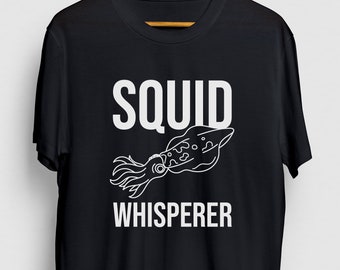 May include: Black t-shirt with white text that reads "Squid Whisperer" and a line drawing of a squid.