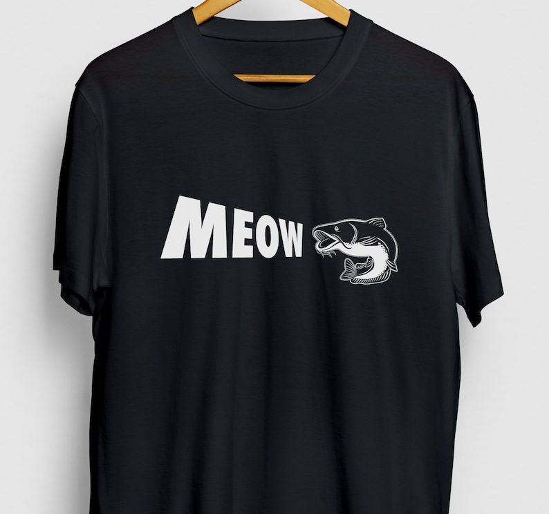 May include: Black t-shirt with a white graphic of a catfish and the word "MEOW" printed on the front.