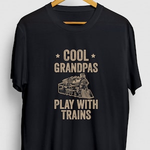May include: Black t-shirt with a vintage-style graphic of a train and the text "Cool Grandpas Play With Trains".
