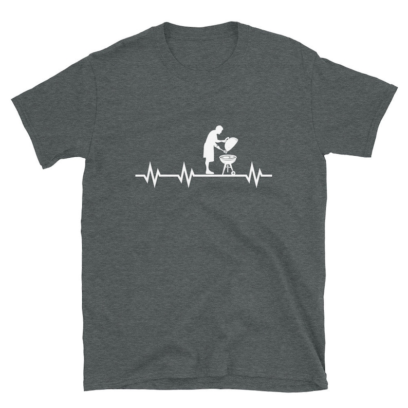 May include: A dark heather gray t-shirt with a white graphic of a person grilling on a barbecue grill with a heartbeat line above it.