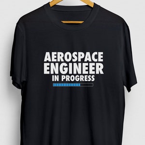 May include: Black t-shirt with white text that reads "Aerospace Engineer in Progress" and a blue progress bar.