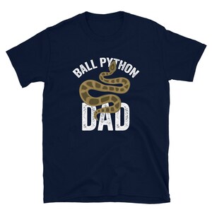 May include: A navy blue t-shirt with a white graphic of a ball python snake and the text "Ball Python Dad".
