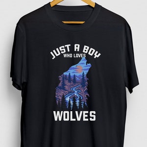 May include: Black t-shirt with a white graphic design of a wolf howling at the moon. The text "Just a boy who loves wolves" is printed on the shirt.