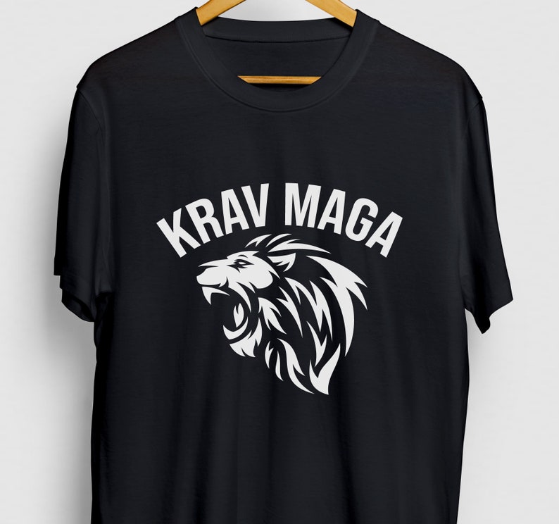 May include: Black t-shirt with a white lion graphic and the text "KRAV MAGA" in white.