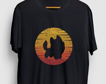May include: Black t-shirt with a retro-style sunset graphic featuring a silhouette of a dog. The graphic has a distressed, vintage look.