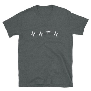 May include: A dark heather grey t-shirt with a white graphic of a drone flying over a heartbeat line.