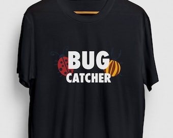 May include: Black t-shirt with a white graphic of a ladybug and a beetle with the text "BUG CATCHER" printed on it.