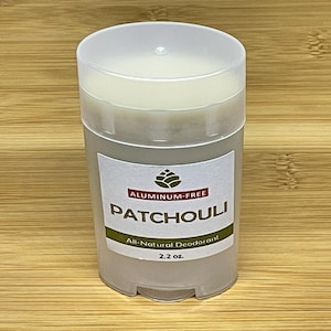 May include: A white deodorant stick with a label that reads "Aluminum-Free Patchouli All-Natural Deodorant 2.2 oz."