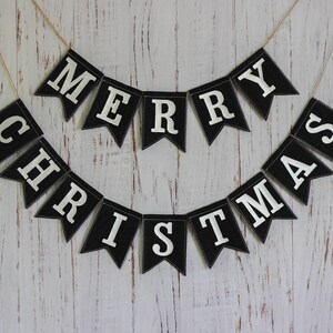 Black and white Merry Christmas fabric banner with alternating flags and matching letters, hanging holiday garland for mantel or fireplace decor.
