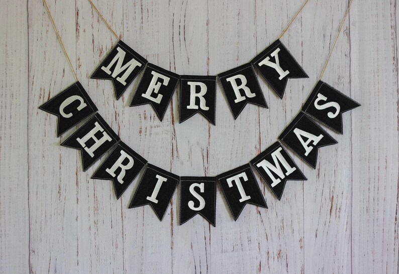 Black and white Merry Christmas fabric banner with alternating flags and matching letters, hanging holiday garland for mantel or fireplace decor.