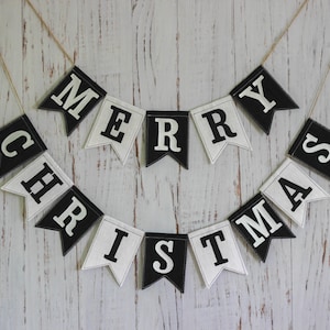 Black and white Merry Christmas fabric banner with alternating flags and matching letters, hanging holiday garland for mantel or fireplace decor.