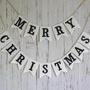 Black and white Merry Christmas fabric banner with alternating flags and matching letters, hanging holiday garland for mantel or fireplace decor.
