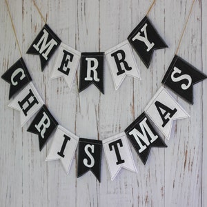 Black and white Merry Christmas fabric banner with alternating flags and matching letters, hanging holiday garland for mantel or fireplace decor.