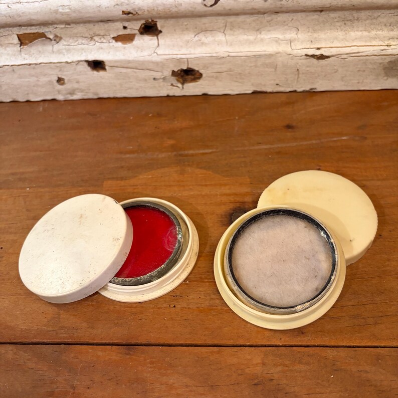 May include: A set of three ceramic mugs with a speckled, matte finish. The mugs are in shades of cream, light brown, and dark brown. Each mug has a simple, minimalist design and a rounded handle.