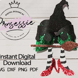 May include: A digital download of a witch with a black hat, green and black dress, and red shoes holding a broom. The witch is standing on a white wooden background. The text "Instant Digital Download SVG DXF PNG PDF" is at the bottom of the image.