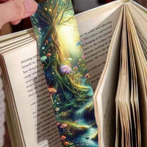 May include: A colourful bookmark featuring a whimsical forest scene with a winding path, a waterfall, and a large tree with glowing lights. The bookmark is printed on a glossy paper.
