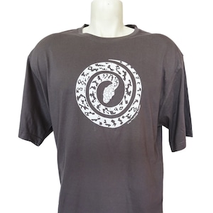 May include: A dark grey t-shirt featuring a white graphic of a snake coiled in a circle. The snake has a patterned design.