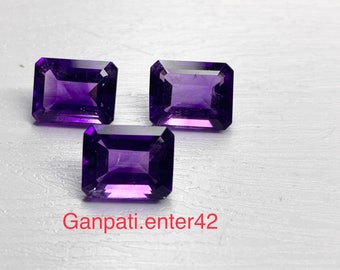 May include: Three purple amethyst gemstones cut in a rectangular emerald shape.