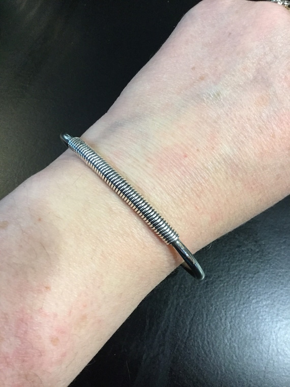 Silver torque bangle with a wire wrap centre - image 3