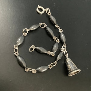 Silver niellio bracelet with a bell charm