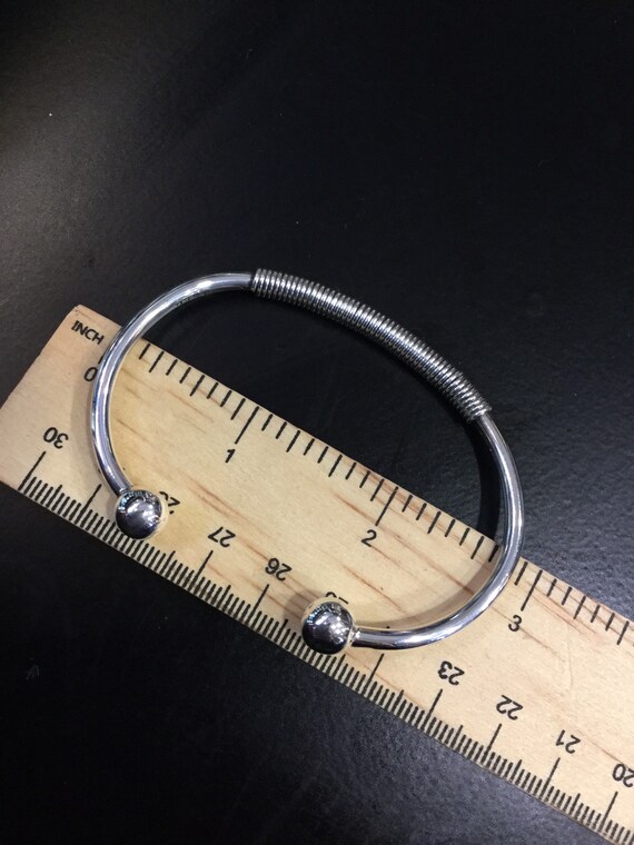 Silver torque bangle with a wire wrap centre - image 7