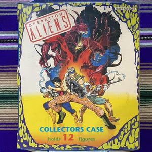 May include: A vintage "Operation: Aliens" collector's case. The box features a colorful illustration of alien creatures and armed figures. The case is designed to hold 12 figures and is suitable for ages 5 and over.