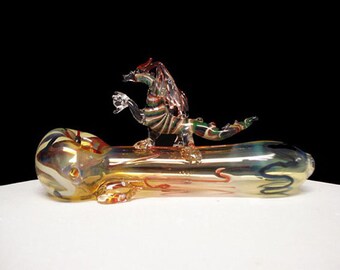 Hand blown glass earth dragon on a pipe.